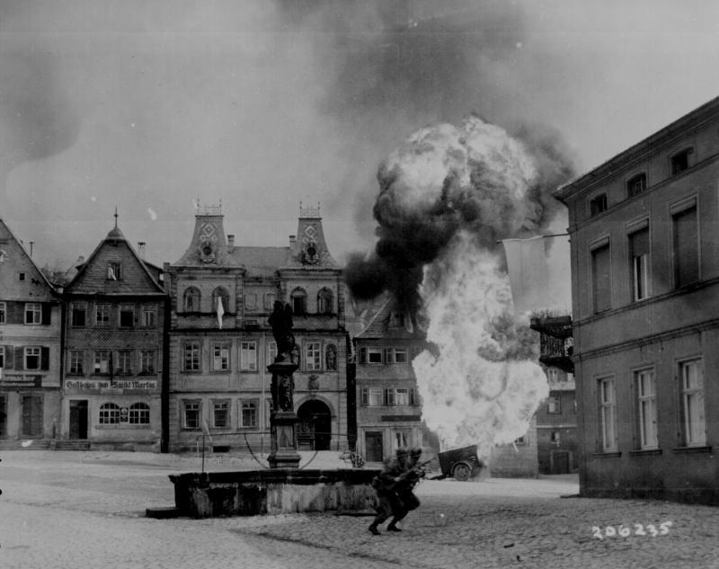 101st Infantry Regiment, dash past a blazing German gasoline trailer