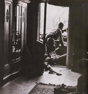 Photos by Robert Capa, American soldier killed by a German sniper.