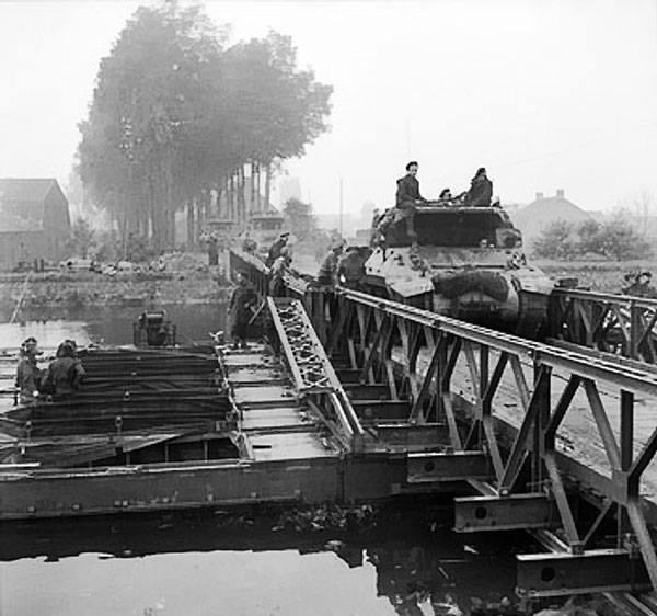 M10 Wolverine tank destroyers crossing a Bailey bridge