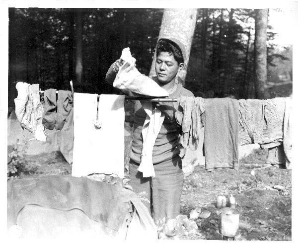 Japanese-American soldier of the 100 Infantry Battalion hanging his laundry