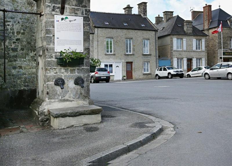 American soldiers stand at the village fountain, Sainte-Marie-du-Mont