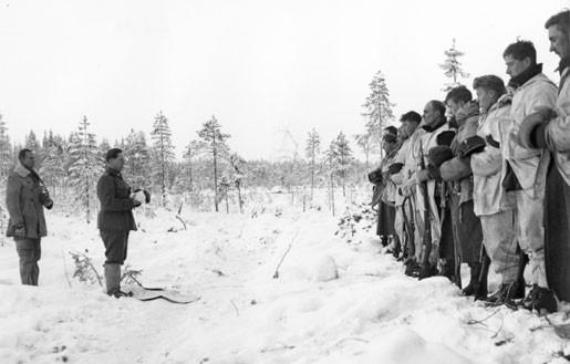 Finnish Army Lieutenant Aarne Juutilainen and his company holding a Christmas service near the Kollaa River,