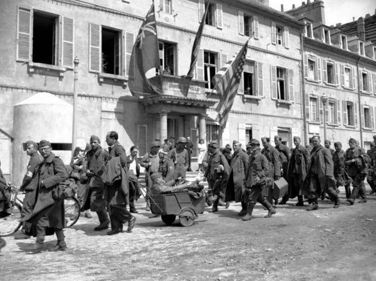 German prisoners file past the Town Hall at Cherbourg