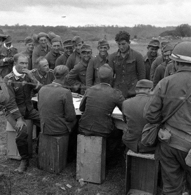 German soldiers are checked by fellow prisoners